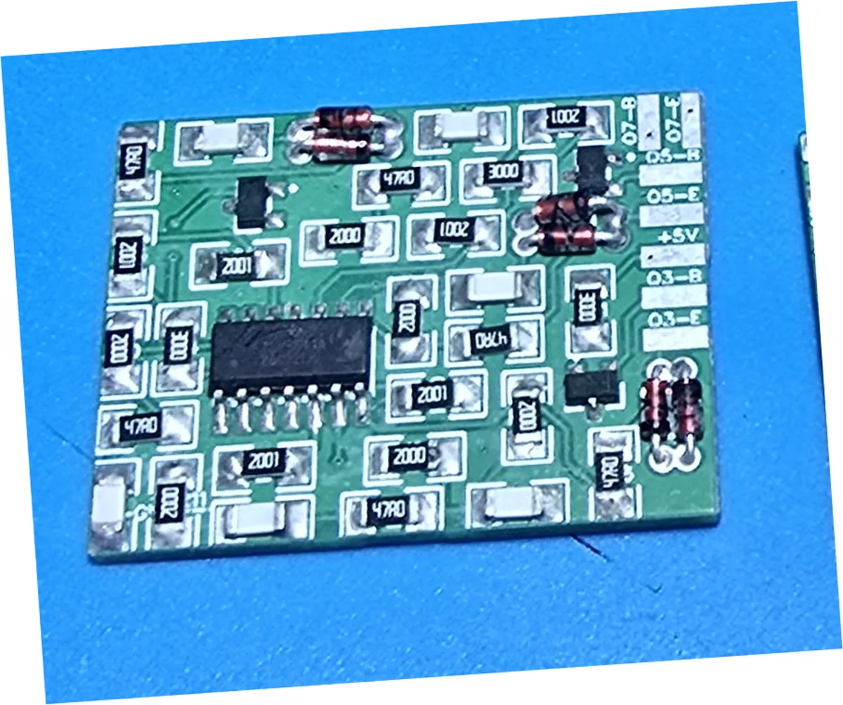The component side of the same board after ultrasonic cleaning. The solder joints are bright and reflective, the white silkscreen is crisp, and the green solder mask is clear with no whitish residue around the components.