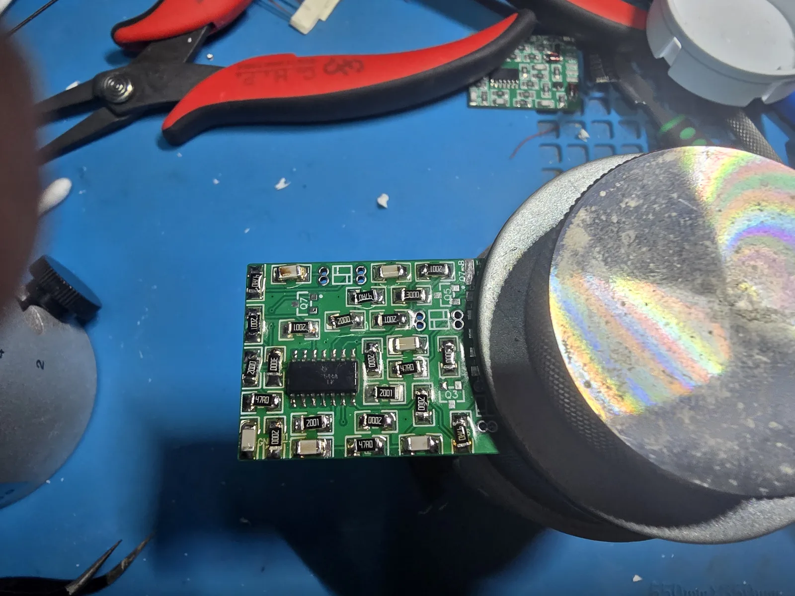 The mod board with all twenty-one resistors and six capacitors fitted, leaving only the transistor and diode positions empty.