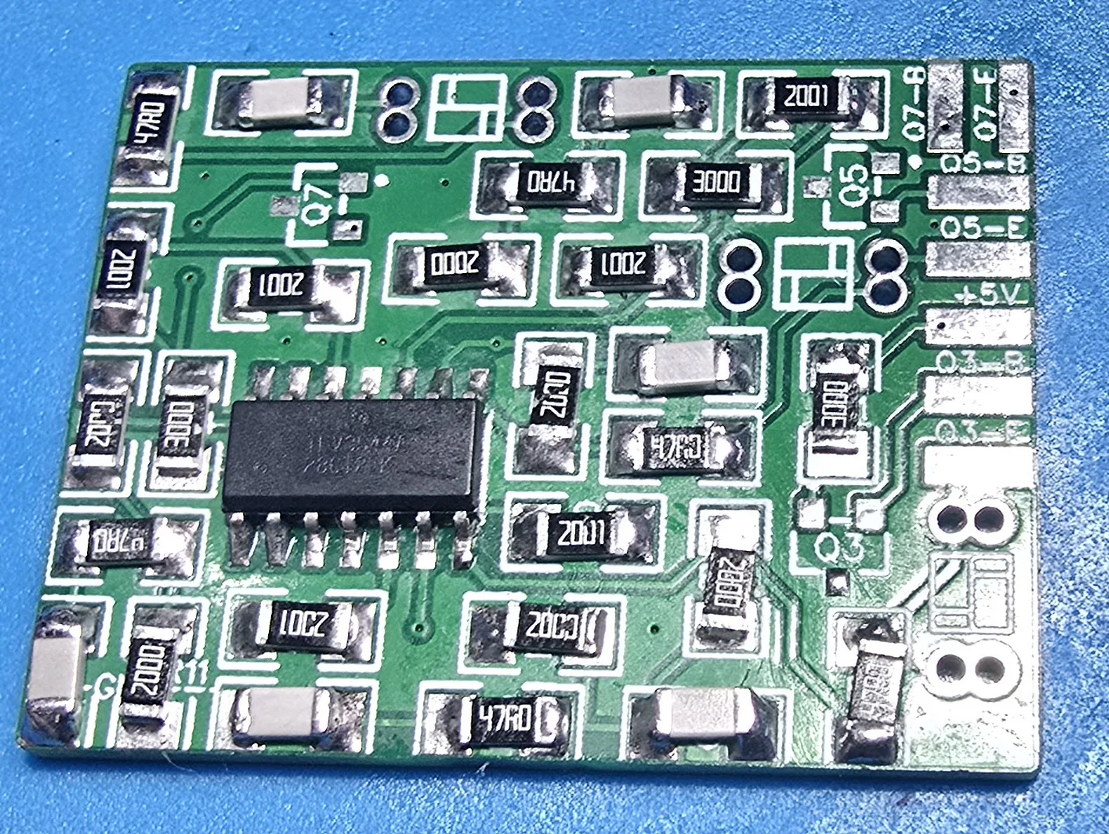 The same mod board after a pass with hot air. The surface-mount resistors and capacitors now sit square and centred inside their silkscreen outlines, and the solder fillets at each end are smooth and even.