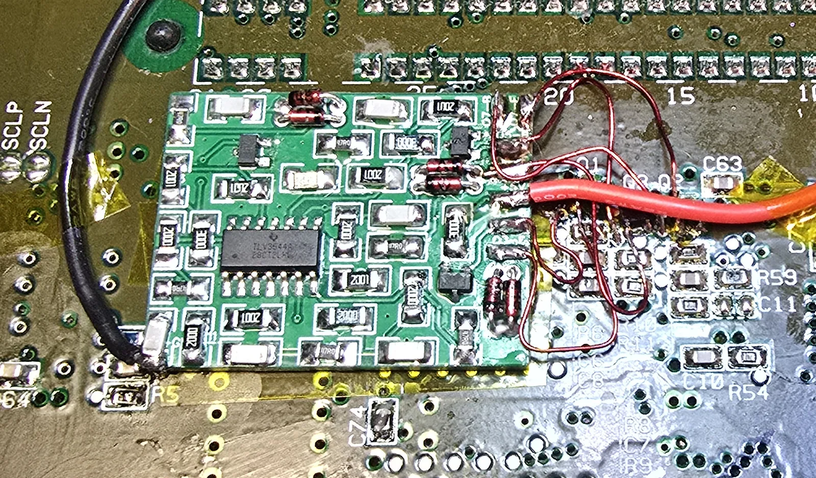 The finished mod board installed on a SNES motherboard with its wires routed and secured.