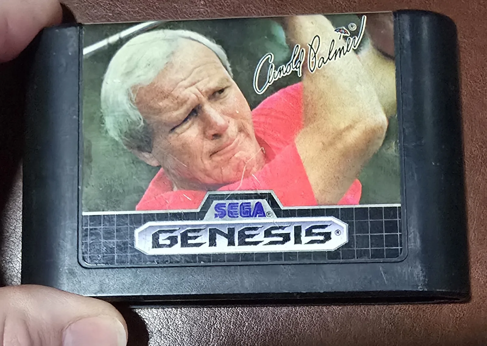 Front label of an authentic Sega Genesis Arnold Palmer Tournament Golf cartridge with Arnold Palmer's signature