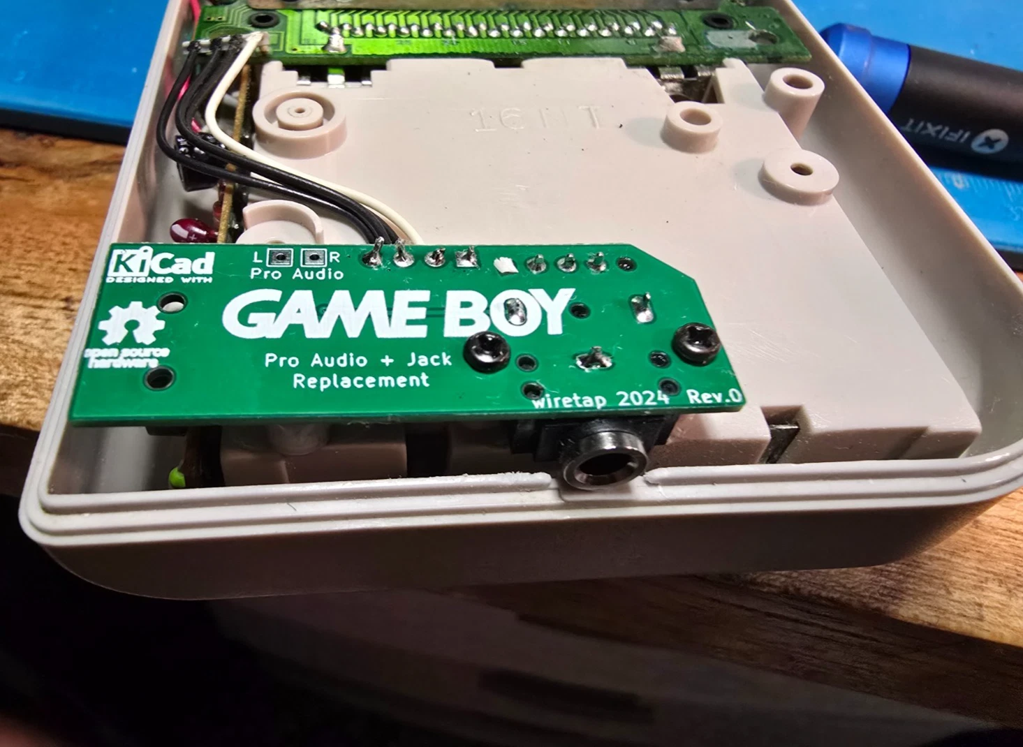 Close-up of the installed board showing the headphone jack centered in the case opening