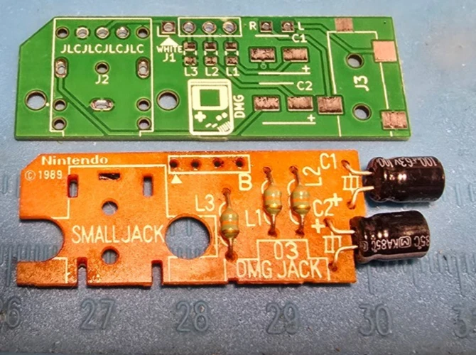 Bare, unpopulated replacement PCB next to the original DMG headphone board