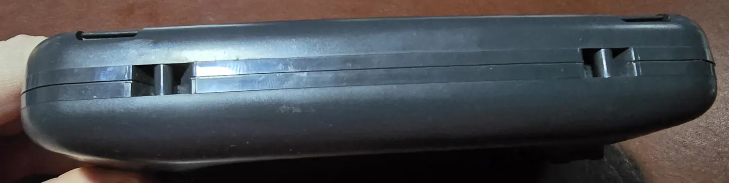 Bottom edge of the Game Gear showing the battery door latches