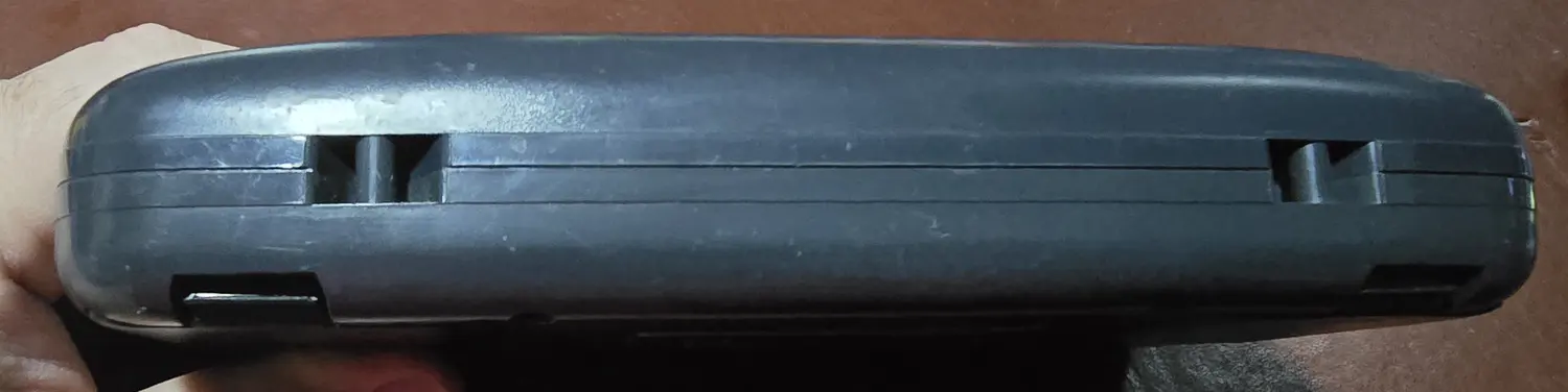 Bottom edge of the Game Gear showing the battery door latches