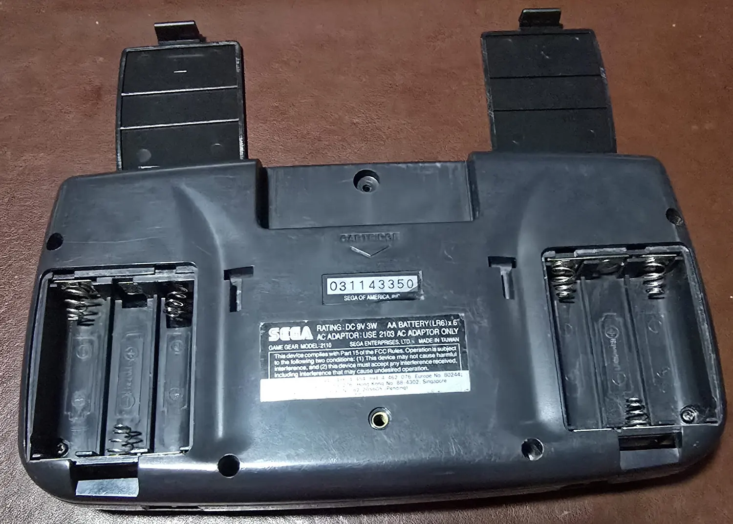Both battery bays with the replacement doors removed, showing clean contacts and springs