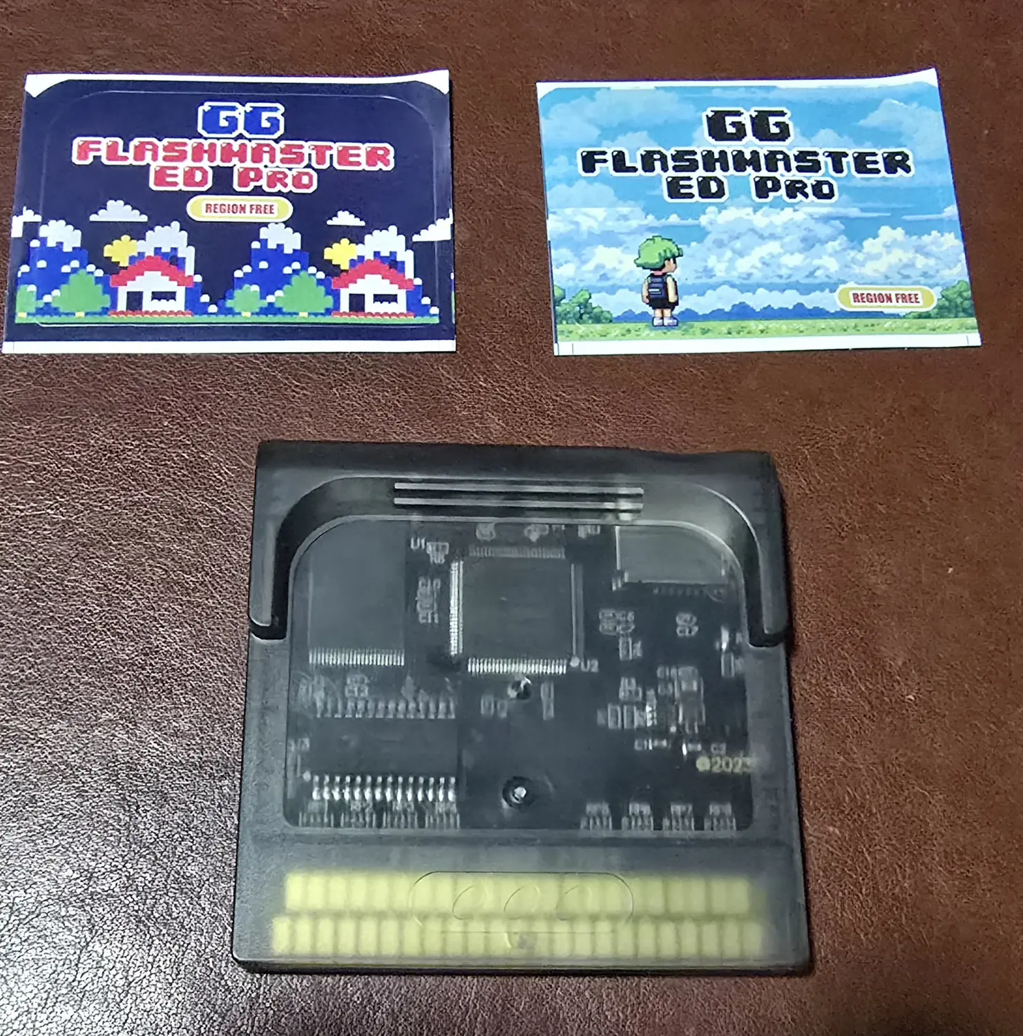 The included Flash Gear Pro+ flash cartridge with the two unapplied GG Flashmaster ED Pro label stickers it shipped with