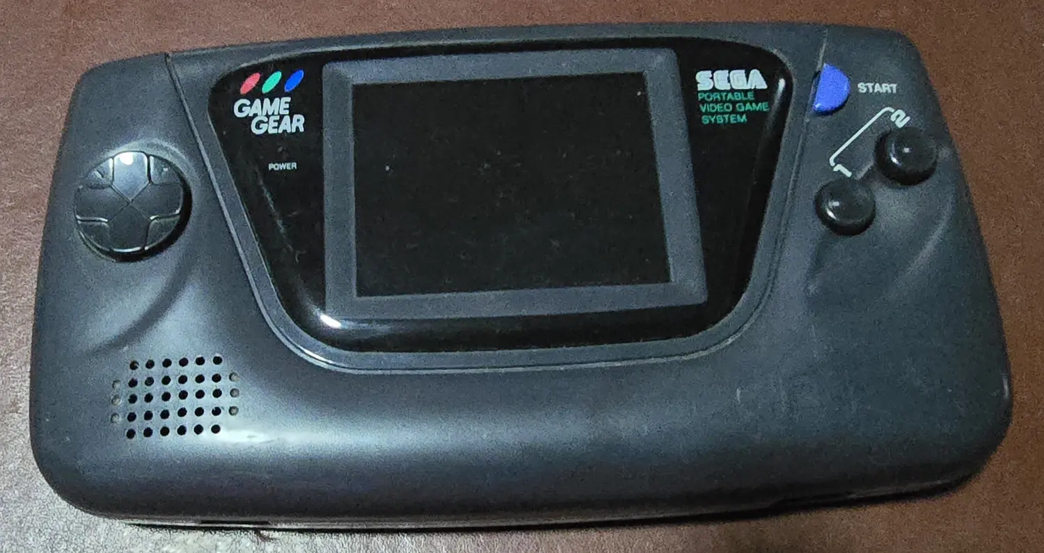 Front of the Sega Game Gear included in this bundle, powered off, showing the original screen bezel and intact controls