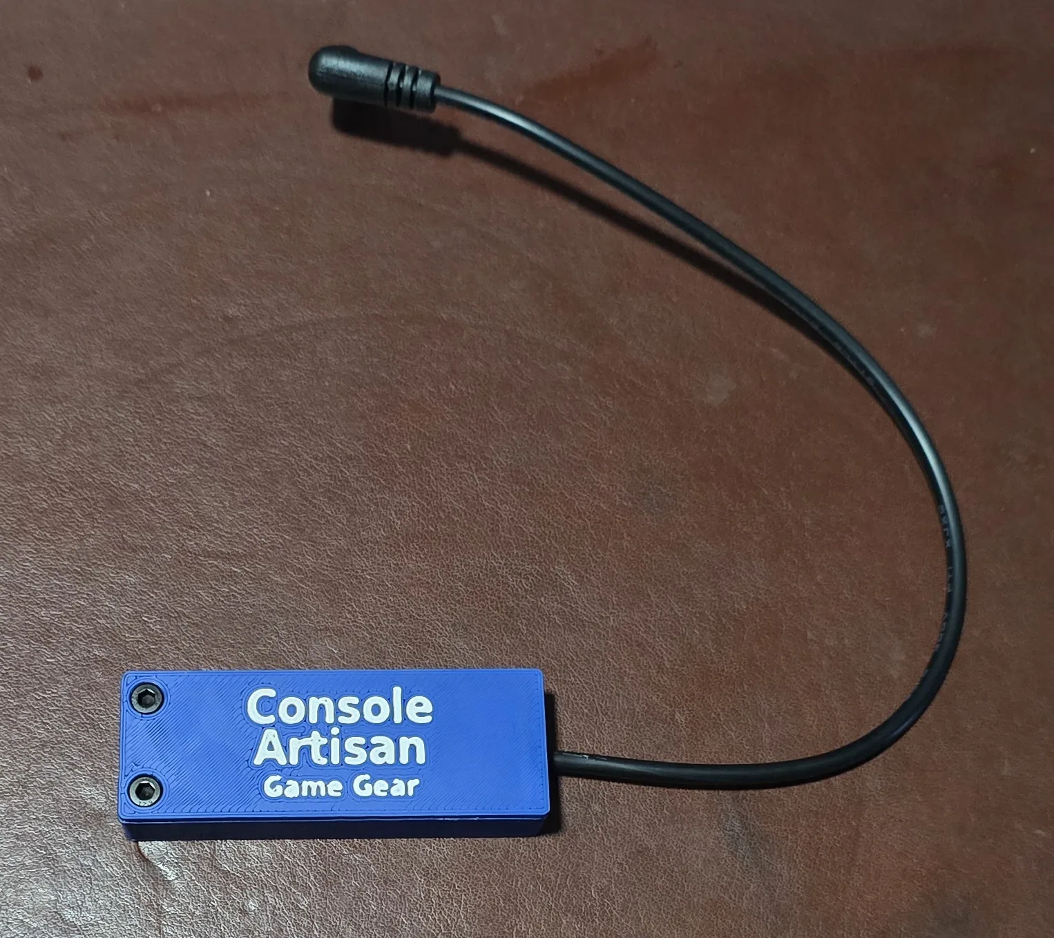Front of the Console Artisan USB-C 9V Game Gear power adapter with its right-angle barrel cable
