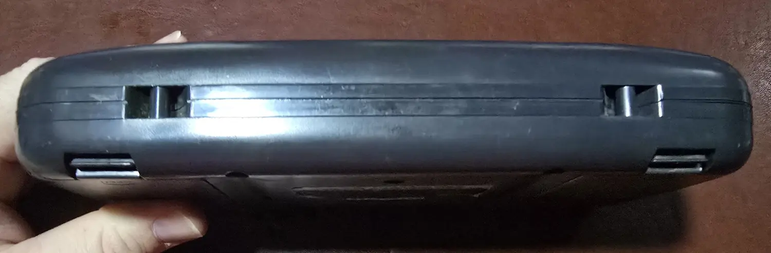 Bottom edge of the Game Gear showing the battery door latches