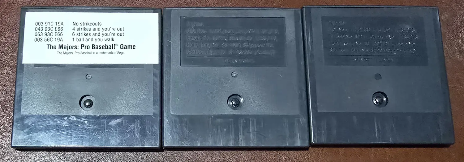 Backs of the three included cartridges, with a code sticker present on the Majors Pro Baseball cart