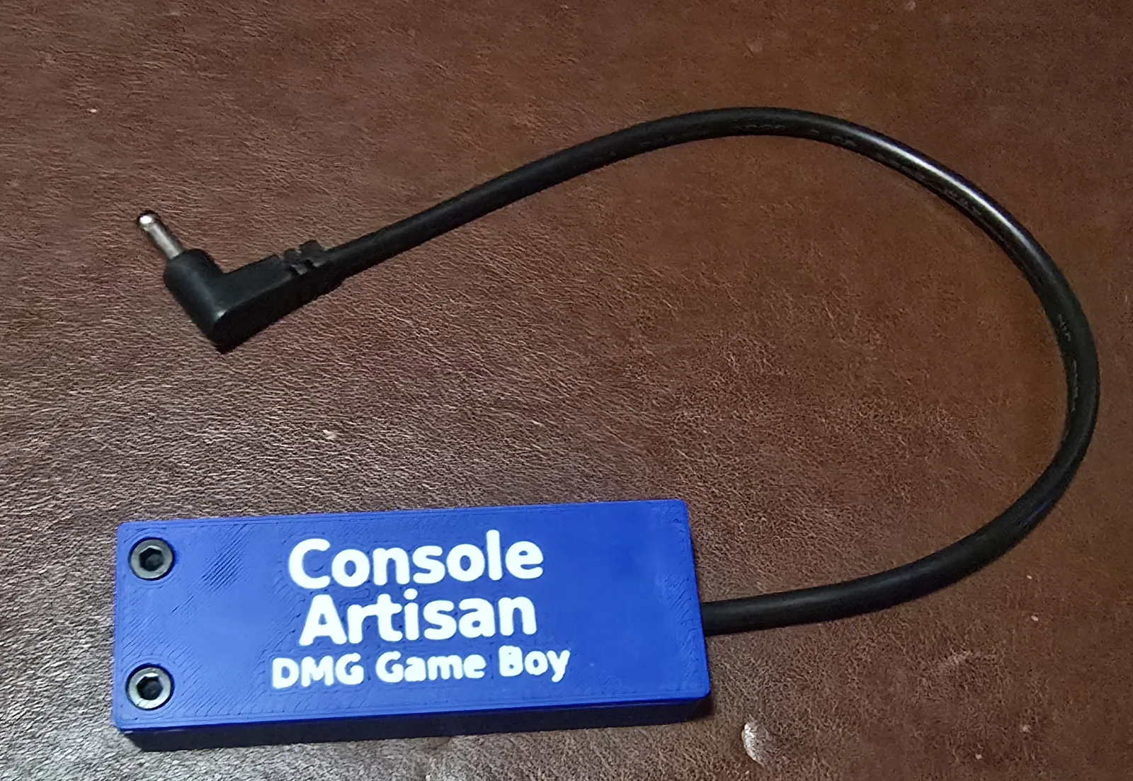 Front of a Console Artisan USB-C 6V power adapter for the Game Boy DMG-01. Two of these are included.