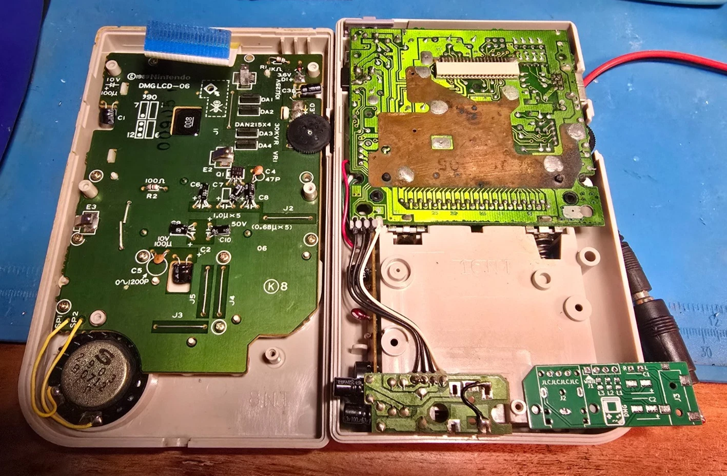 The original Nintendo DMG headphone board and the replacement board side by side for size comparison, Game Boy opened
