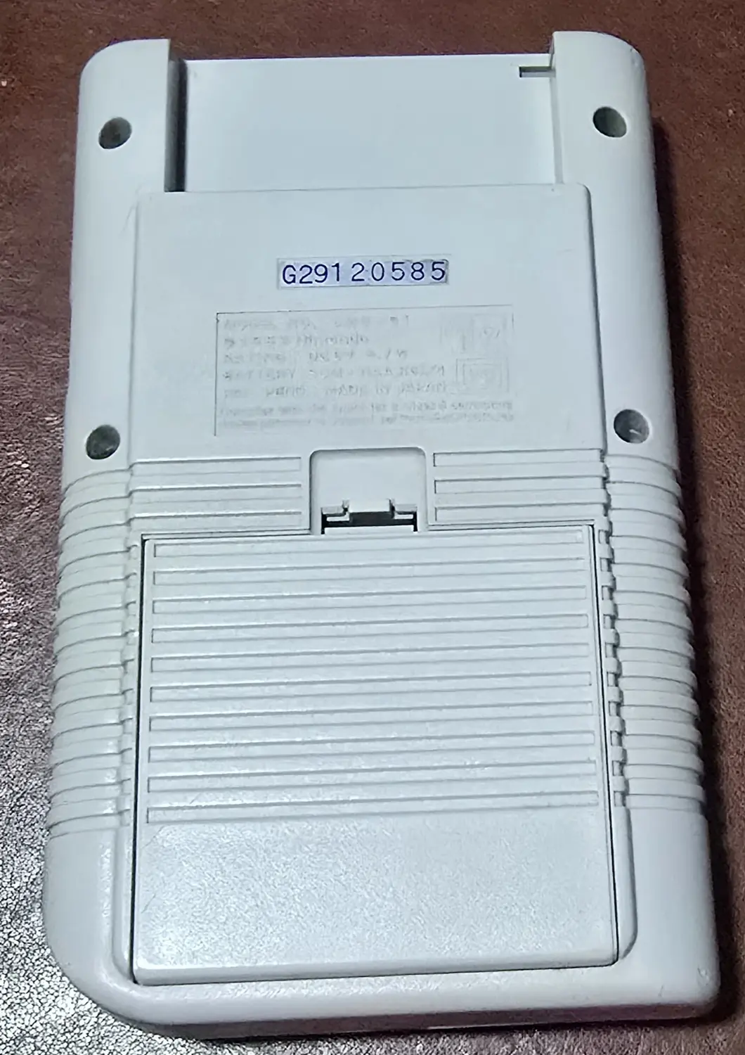 Back of the second Game Boy showing the serial label reading G29120585 and MADE IN JAPAN