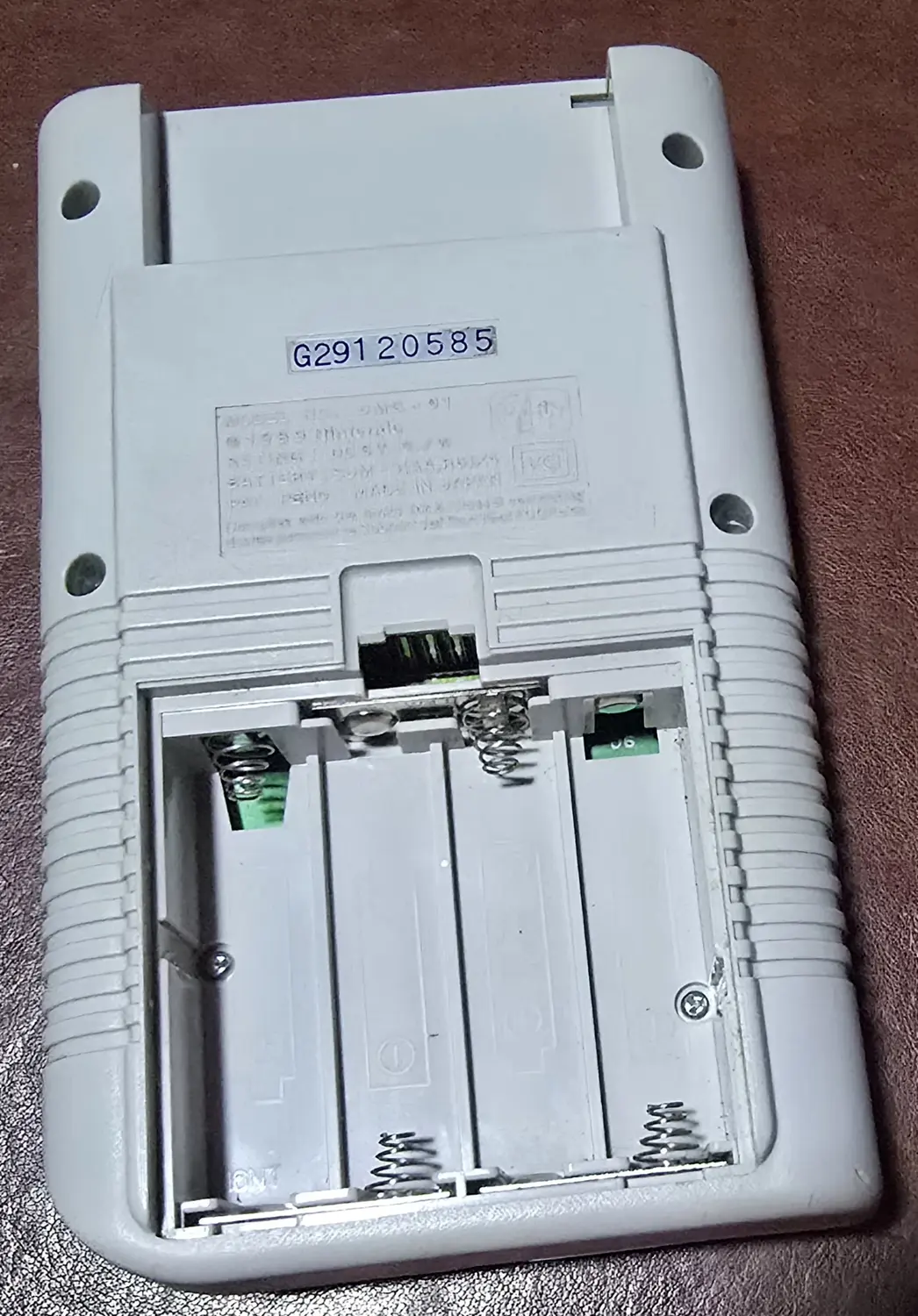 Battery compartment of the second Game Boy with the door removed, showing clean contacts and springs