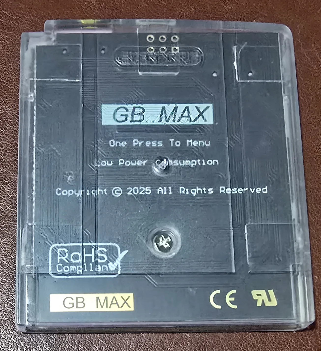 Back of the GB Pro+ flash cartridge, the shell branded GB MAX with One Press To Menu, Low Power Consumption and Copyright 2025 moulded into the plastic