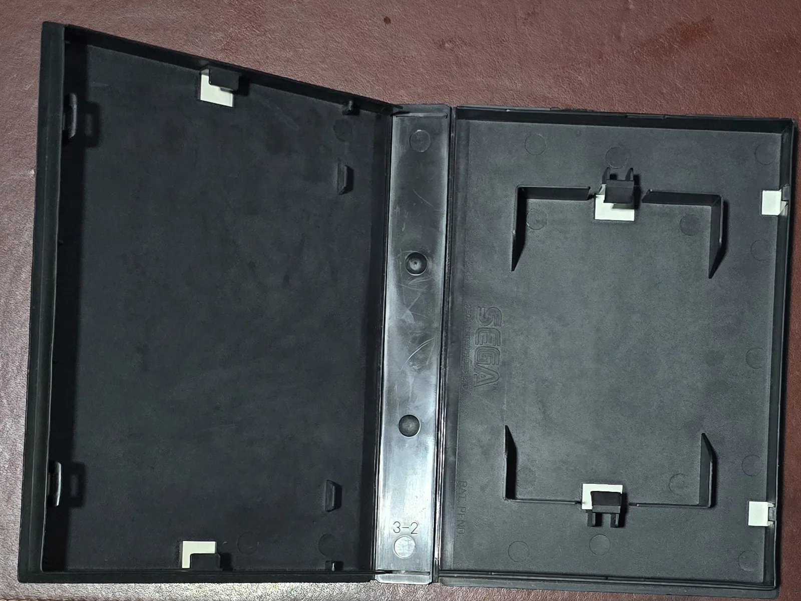 The genuine Sega Genesis clamshell case opened, showing the interior tray