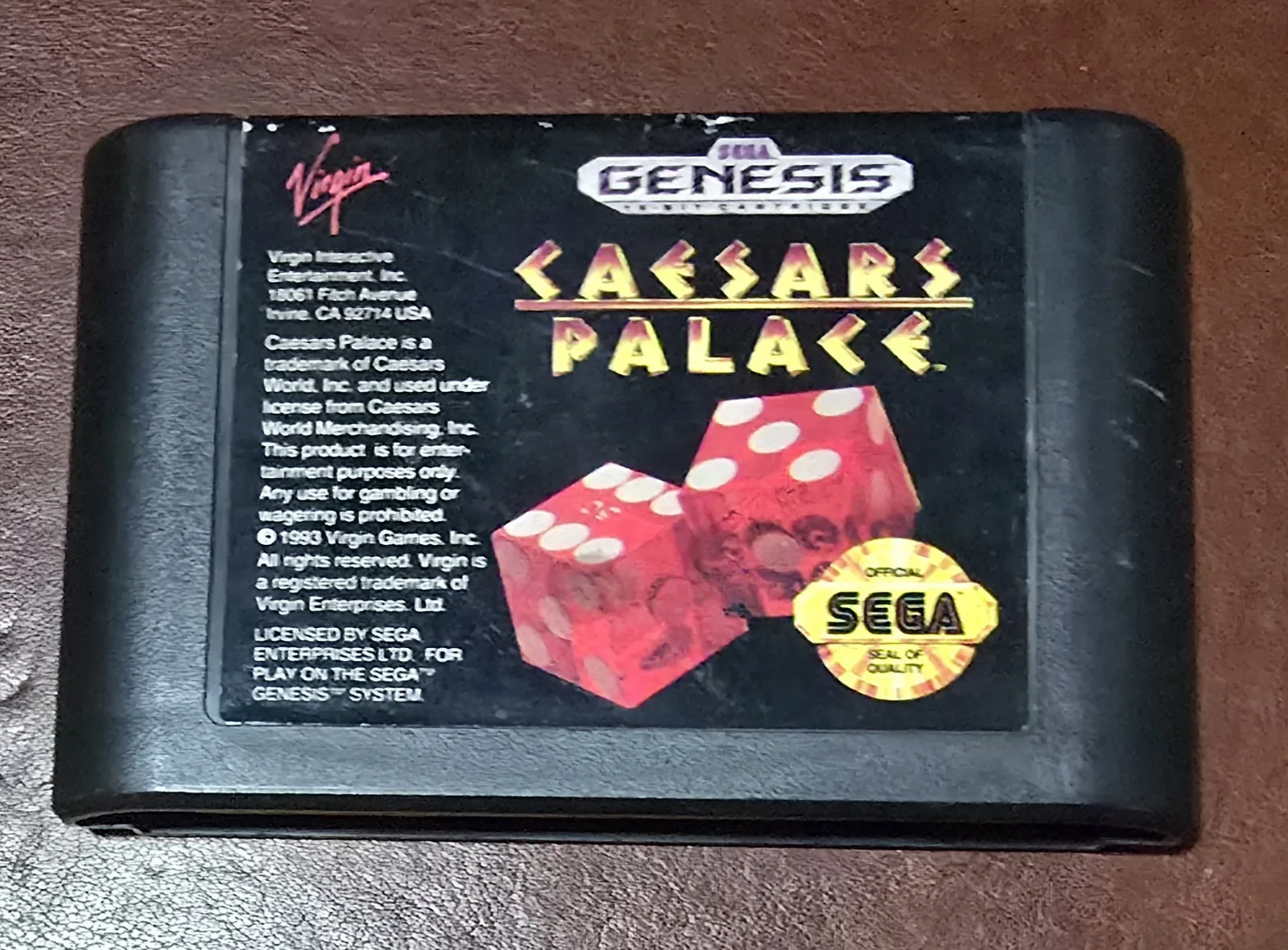 Front label of an authentic Sega Genesis Caesars Palace cartridge by Virgin, with red dice art