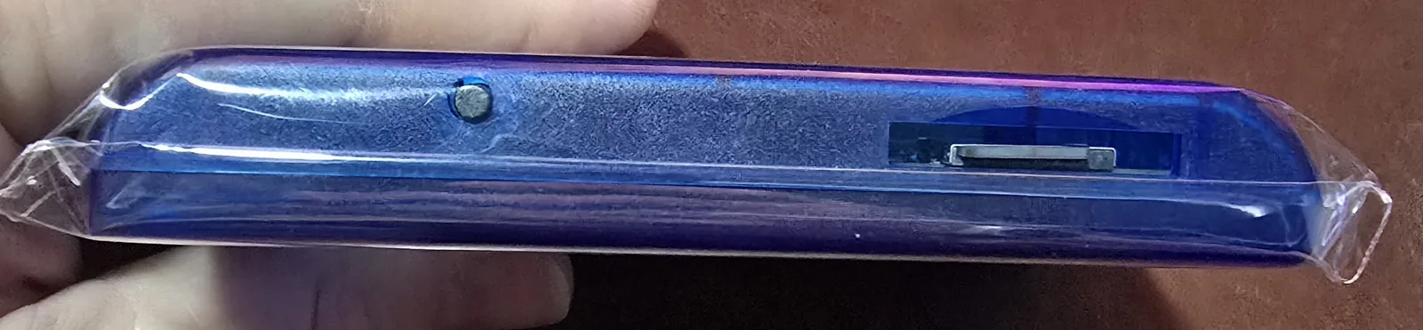 Top edge of the Genesis flash cart showing the onboard pause/reset button and the microSD card slot