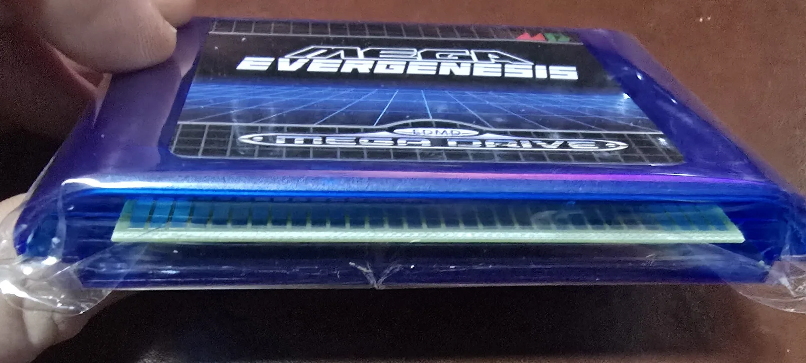 Bottom edge of the Genesis flash cart showing the gold edge-connector pins
