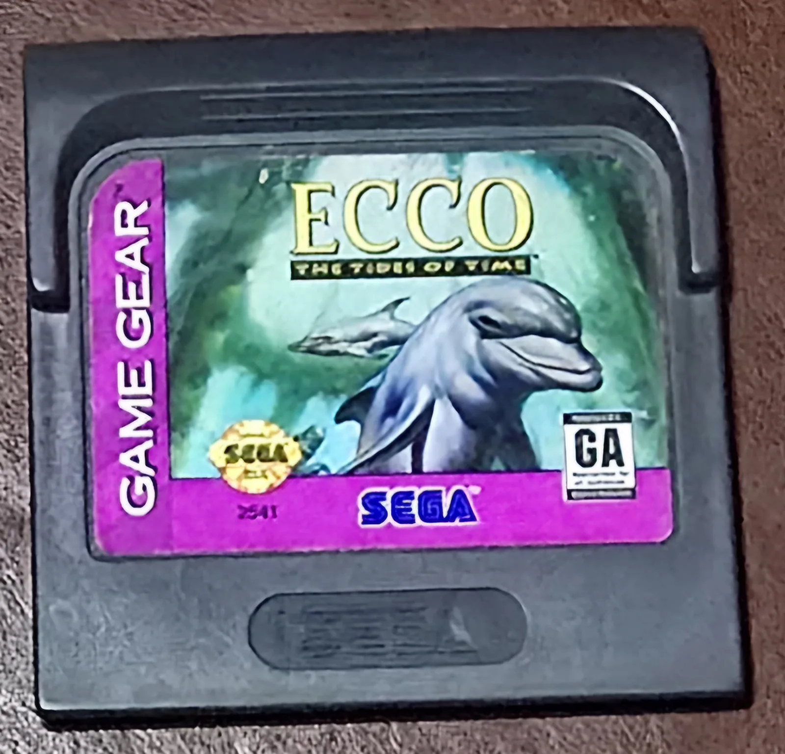 Front of an authentic Sega Game Gear Ecco The Tides of Time cartridge, the purple dolphin label