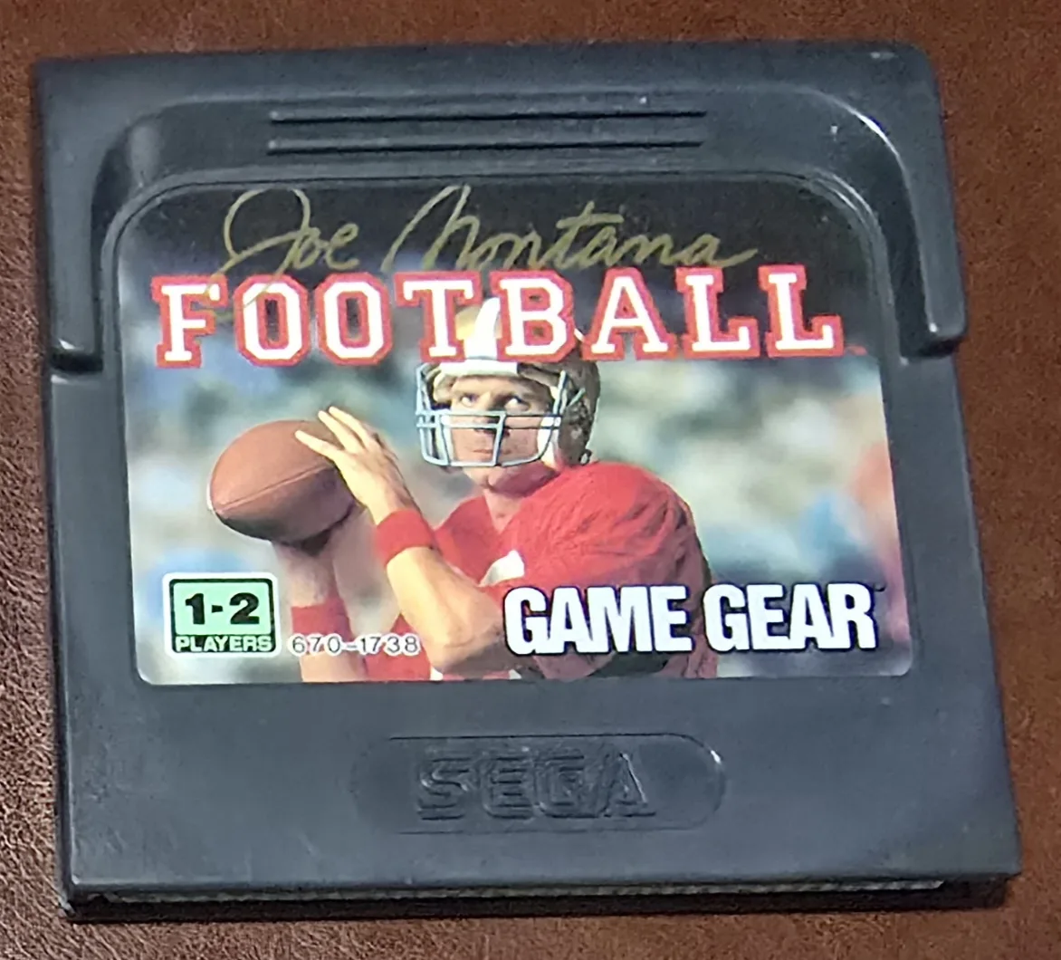 Front of an authentic Sega Game Gear Joe Montana Football cartridge with Joe Montana's photo and signature