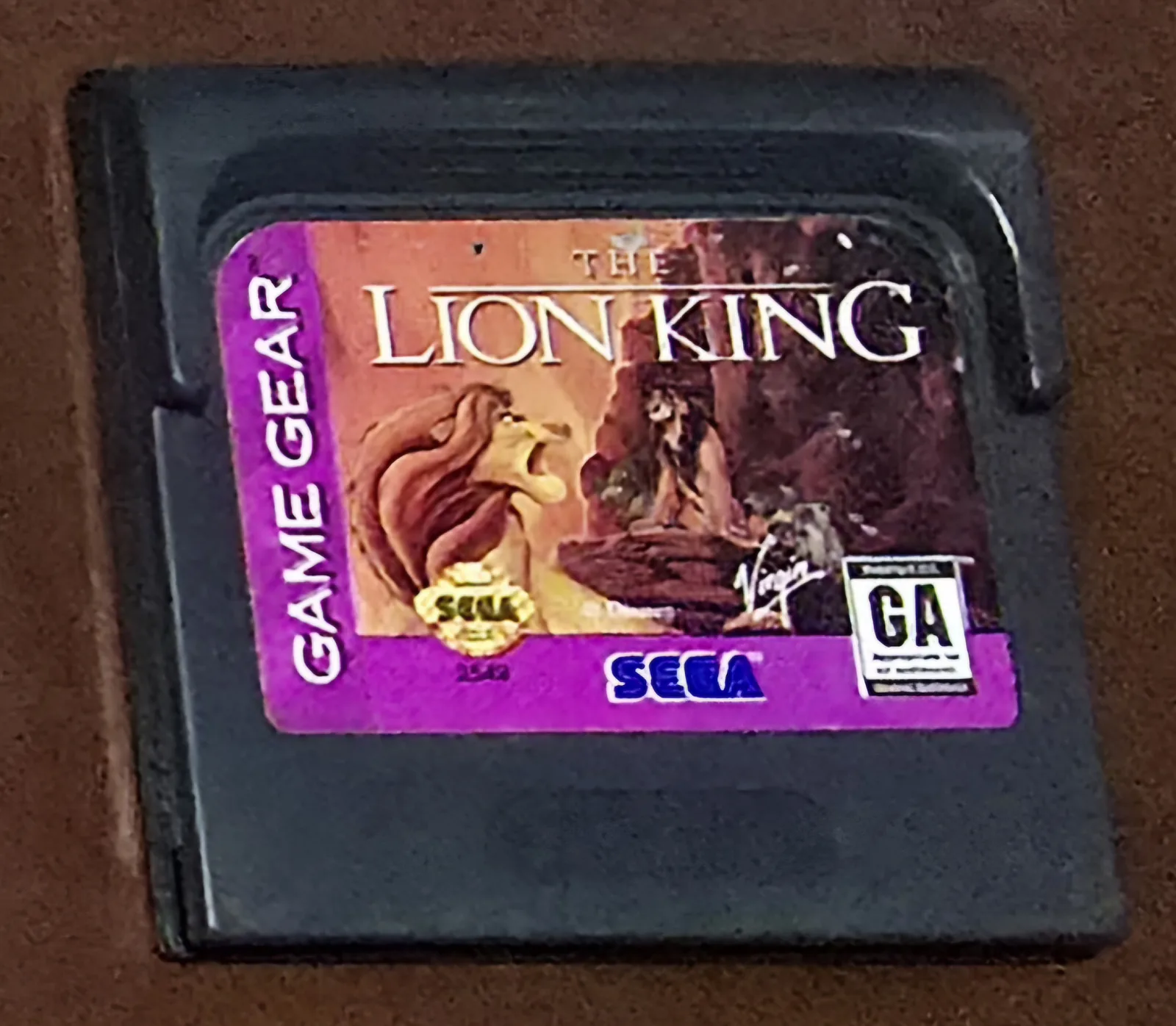 Front of an authentic Sega Game Gear The Lion King cartridge, the purple Simba label