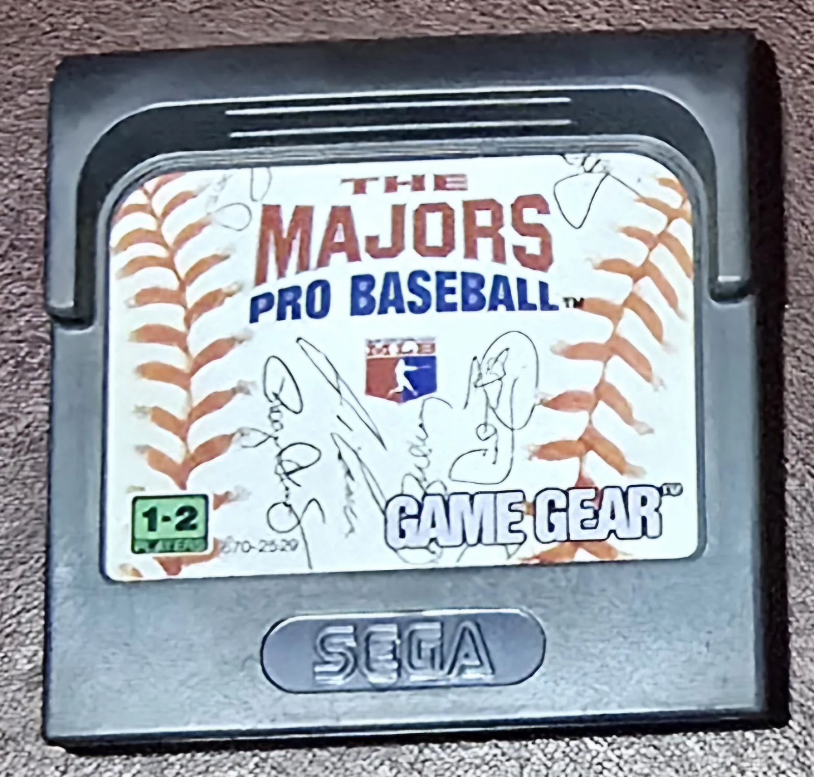 Front of an authentic Sega Game Gear The Majors Pro Baseball cartridge; the label is a close-up of a signed baseball with the MLB logo
