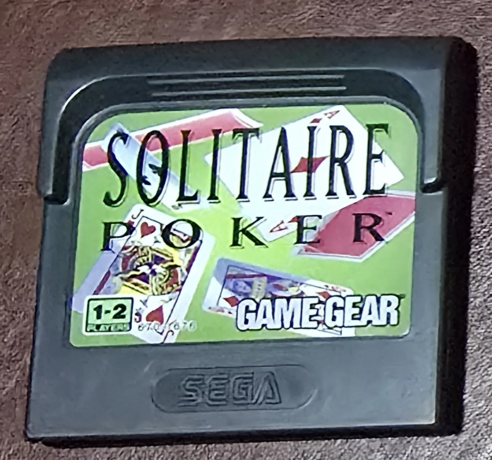 Front of an authentic Sega Game Gear Solitaire Poker cartridge, the green card-game label