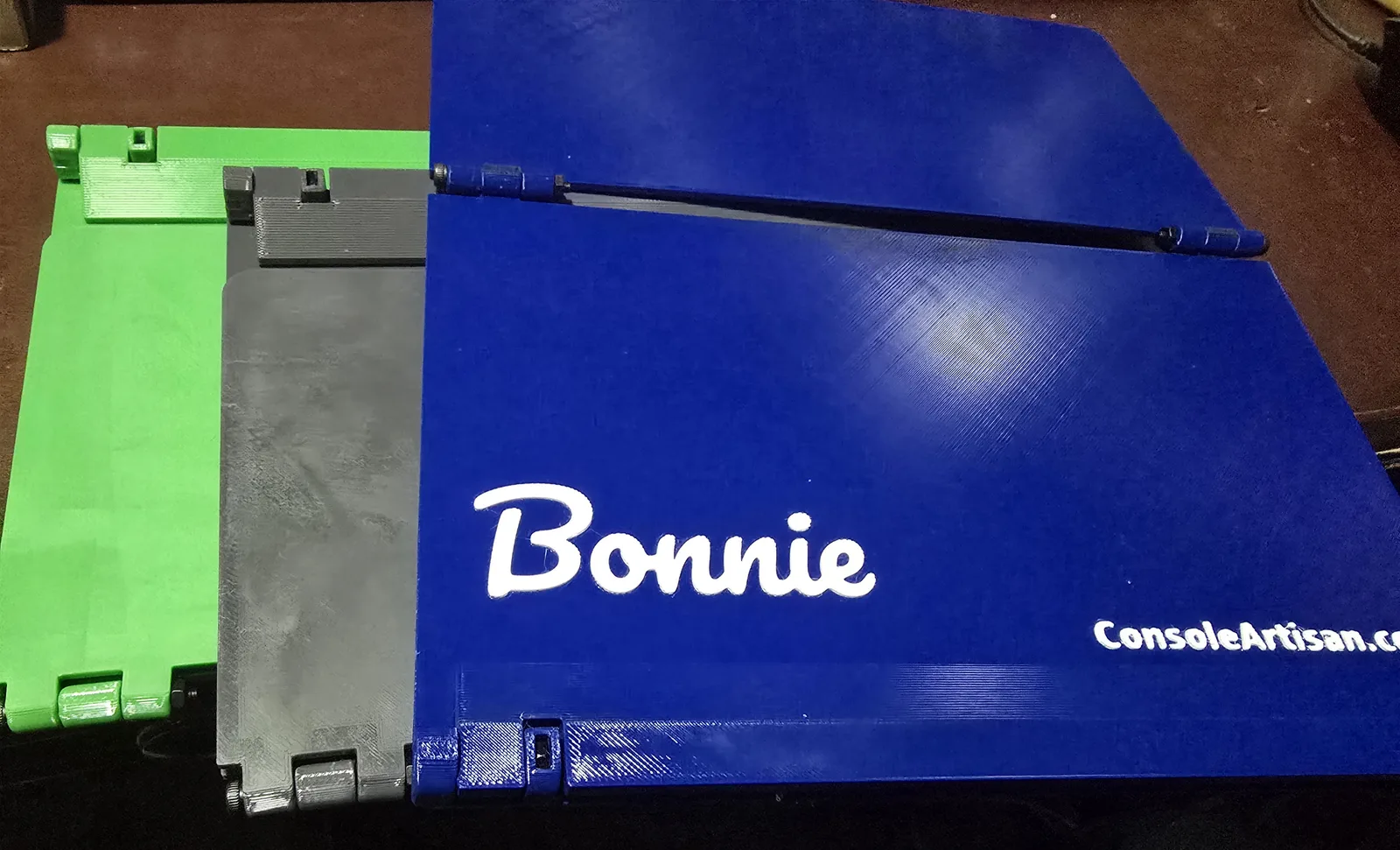 Personalized Mahjong card holders in green, dark gray and blue, the blue one with the name Bonnie in white script