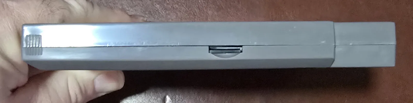 Side of the NES flash cart showing the microSD (TF) card slot