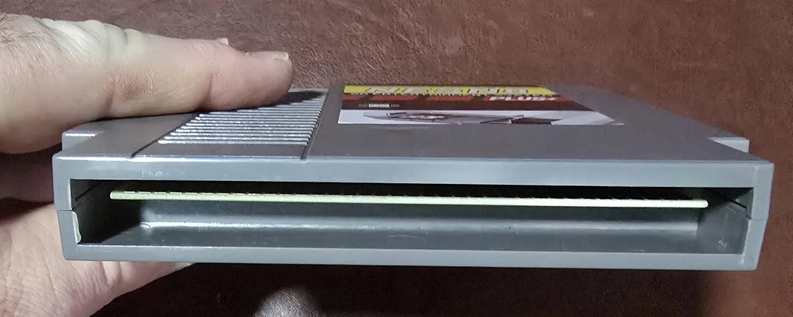 Bottom edge of the NES flash cart showing the gold edge-connector pins