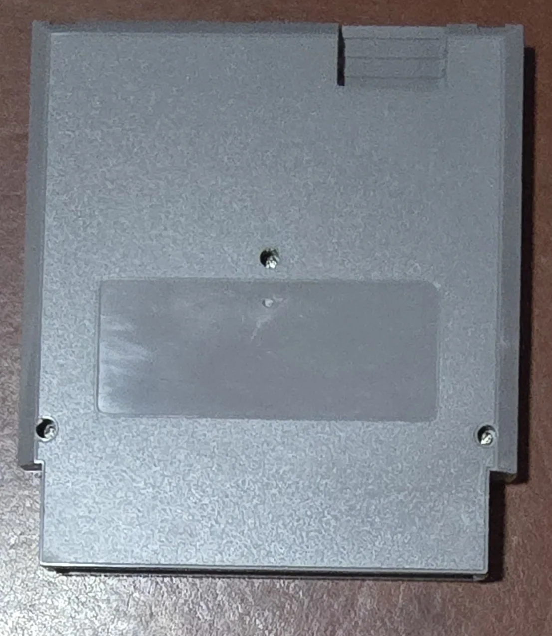 Back of the gray NES flash cart shell