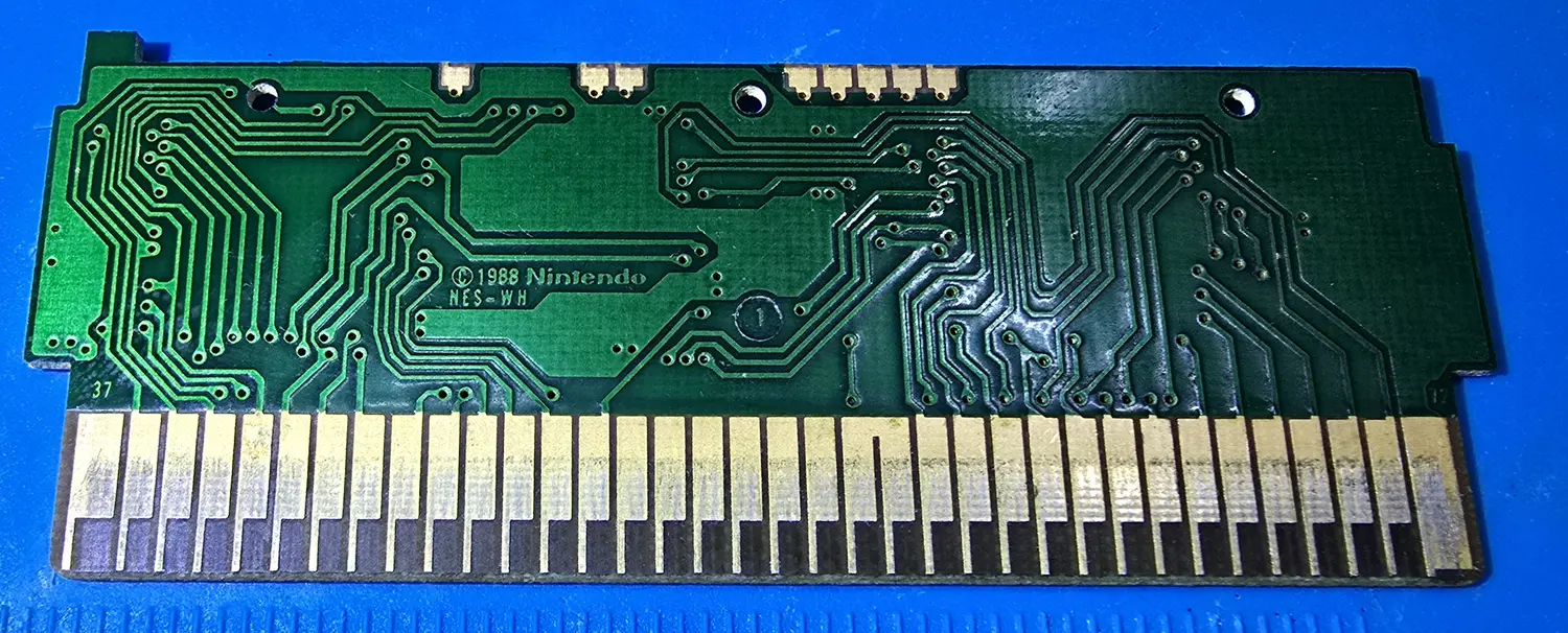 Solder side of the 3-in-1 circuit board, silkscreened (c) 1988 Nintendo NES-WH, with clean gold edge contacts