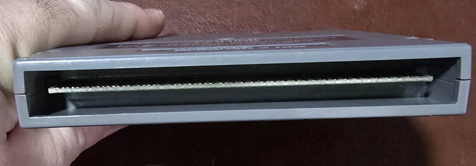 Edge of the NES cartridge showing the cleaned gold edge-connector contacts