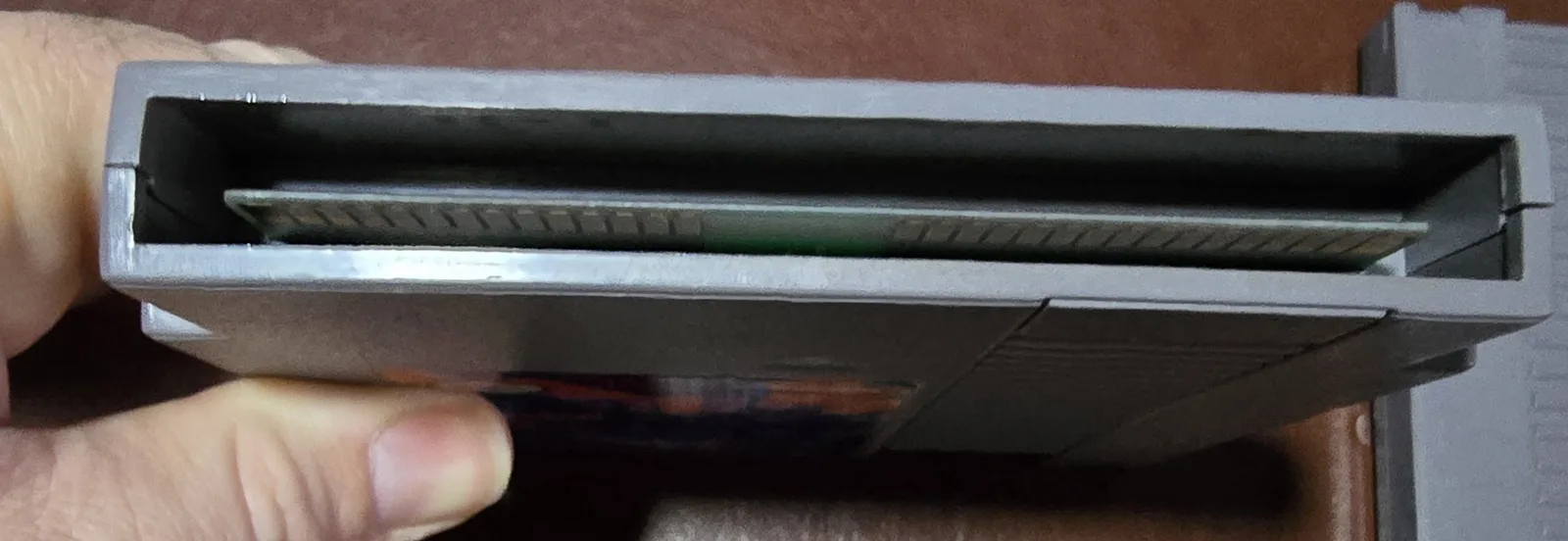 Edge of the cartridge showing the cleaned gold edge-connector contacts, part of the test-and-clean process