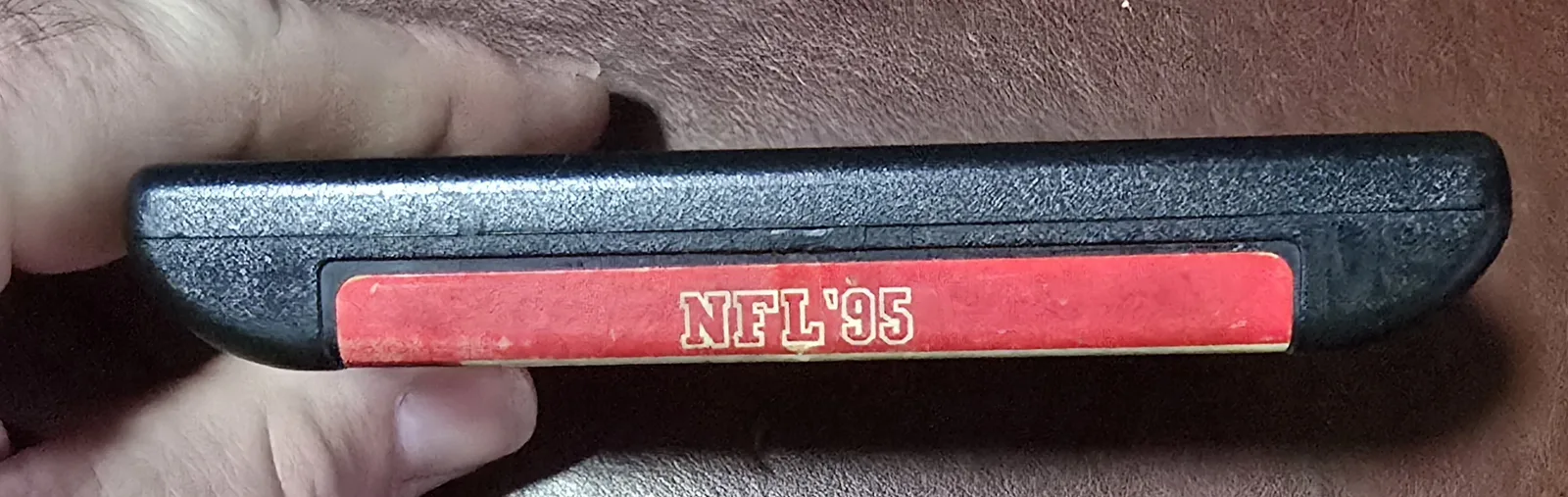Top spine label reading NFL '95 on the Genesis cartridge