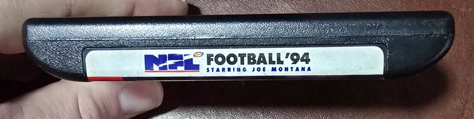 Top spine label reading NFL Football '94 Starring Joe Montana on the Genesis cartridge