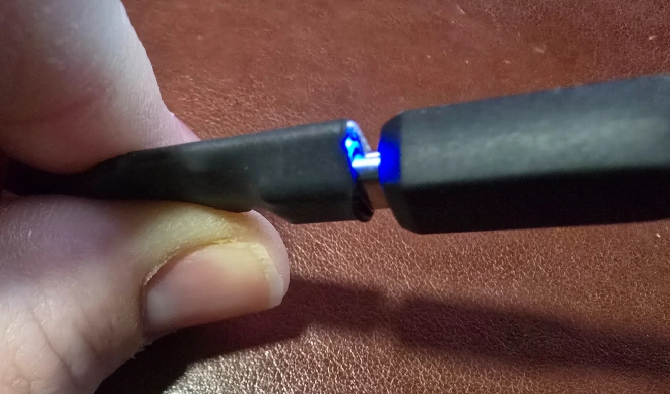 Close-up of a prototype Game Gear dongle with its PD-status LED lit
