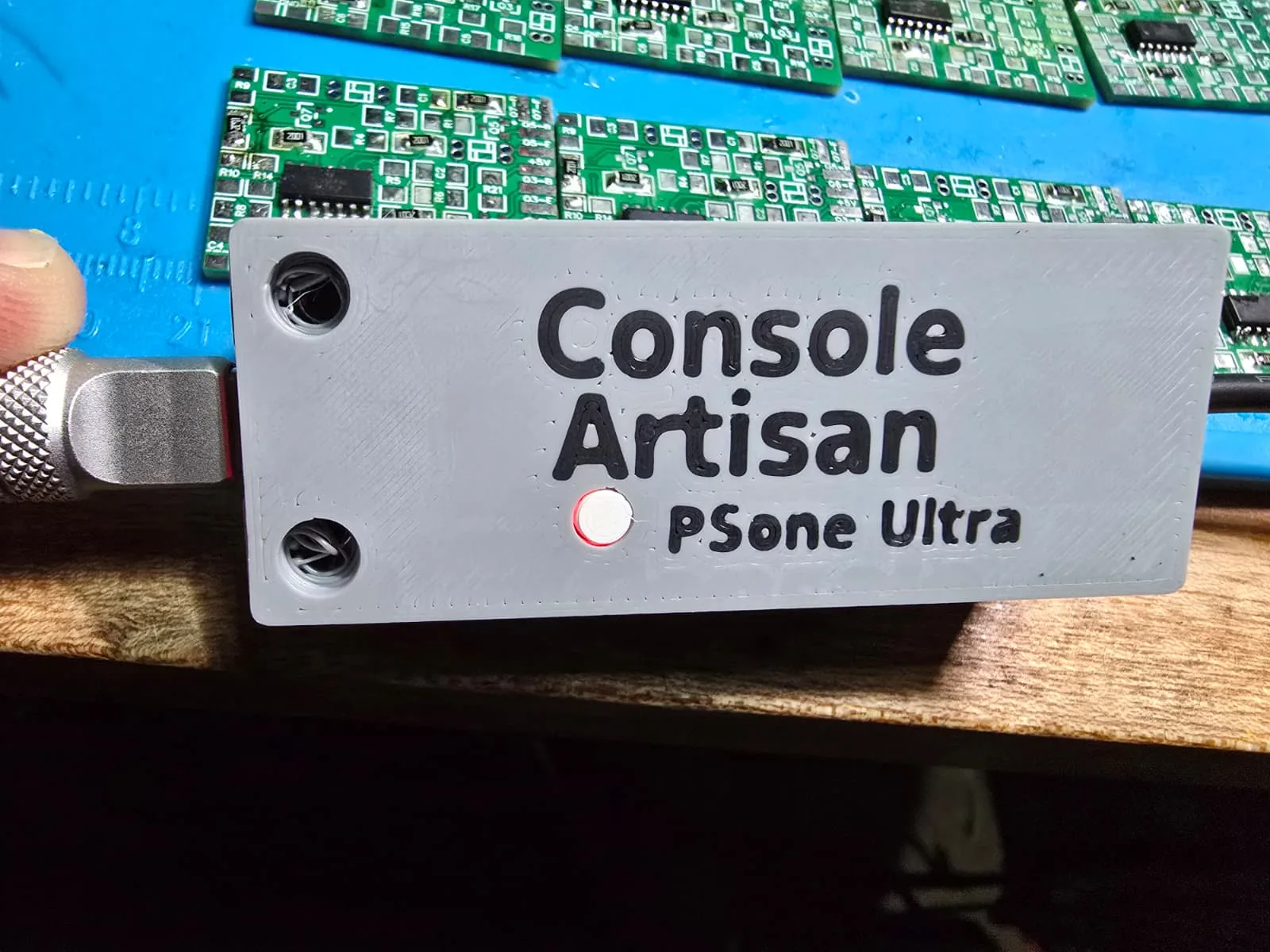 The lid of the adapter with its status LED lit red and a USB-C cable plugged into the far end