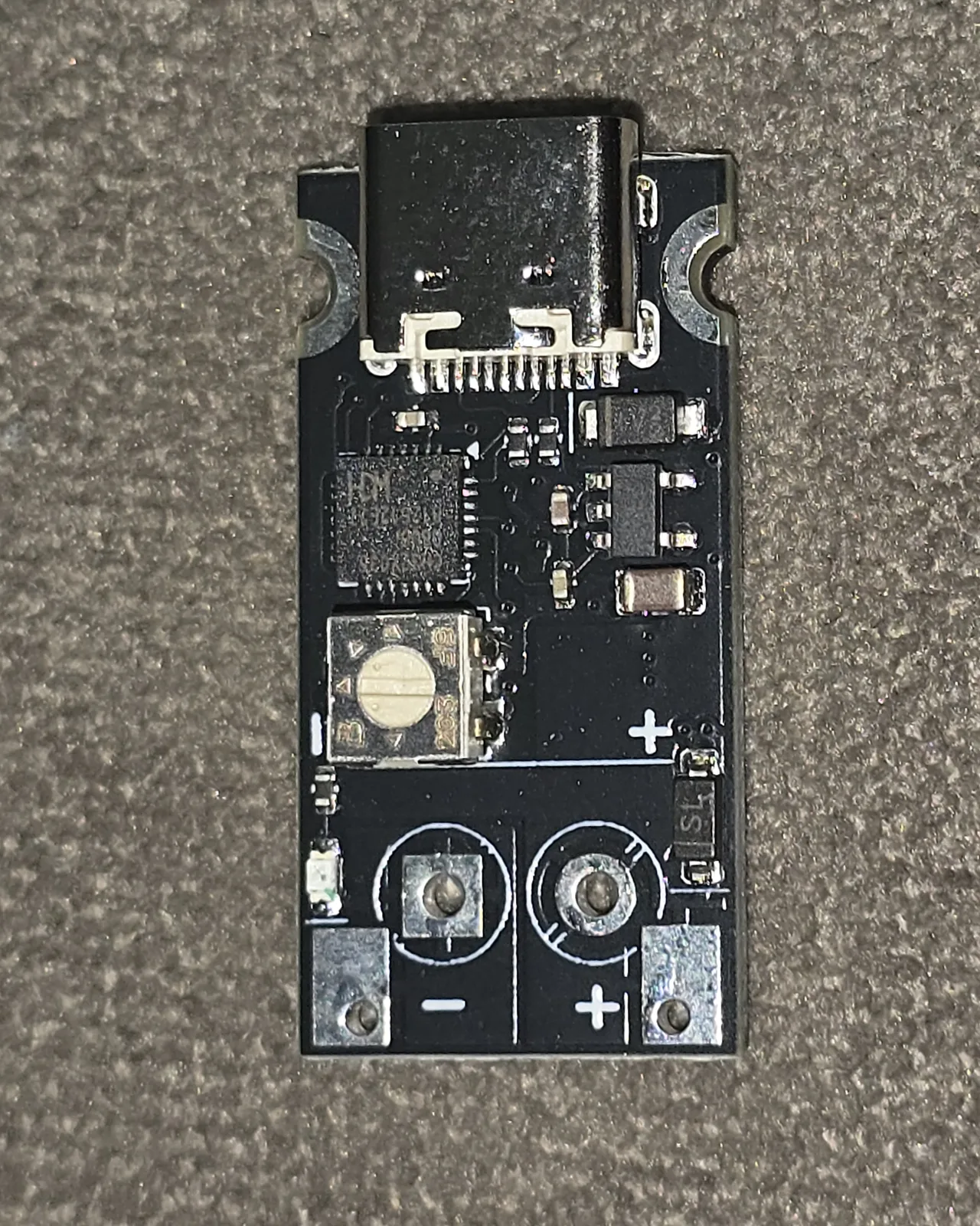 Close-up of the CentyLab PPSTrigger V1.2 USB-C Power Delivery trigger board with its USB-C connector, controller chip and output pads