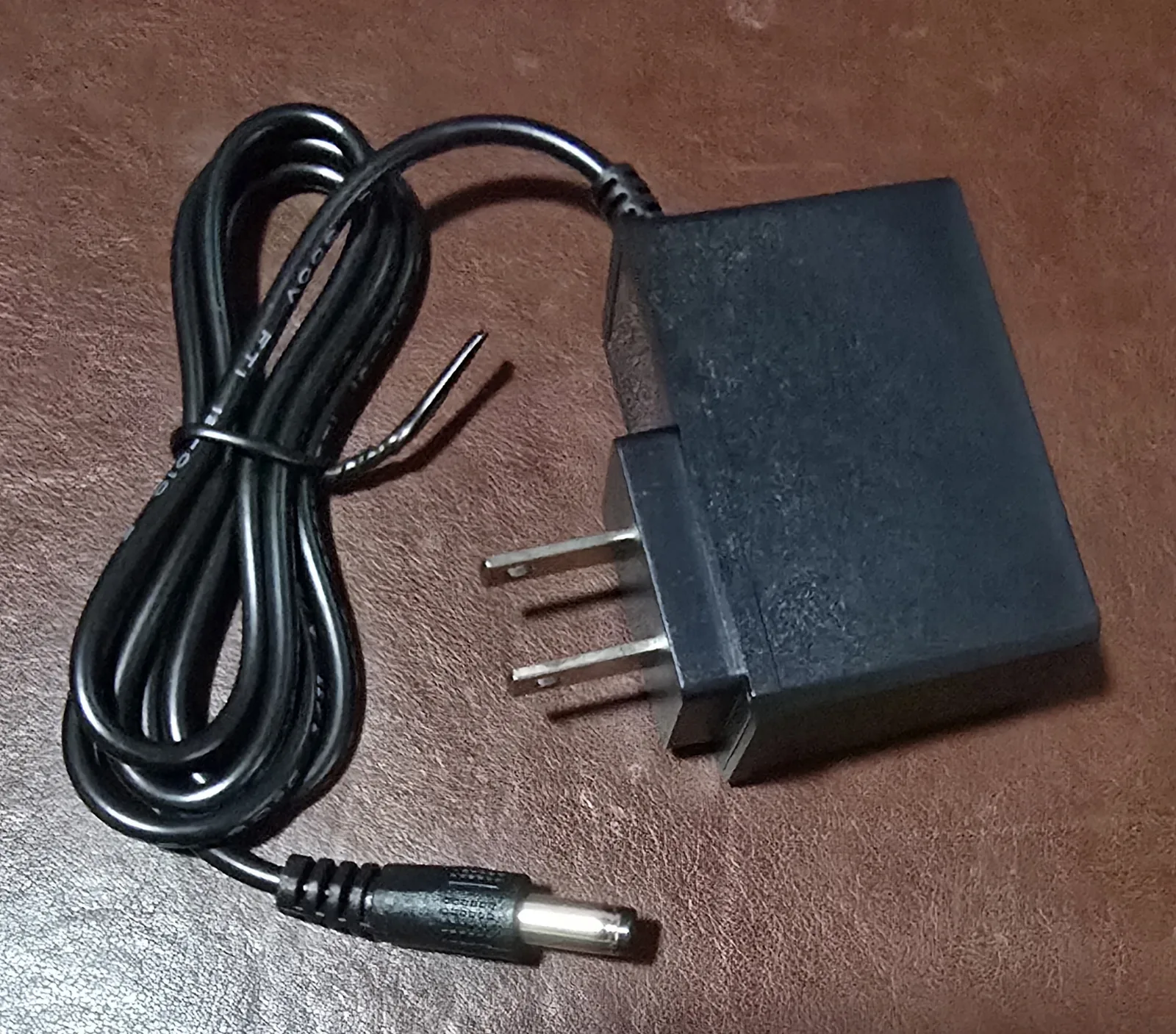 The included 5V US wall power adapter with a barrel plug