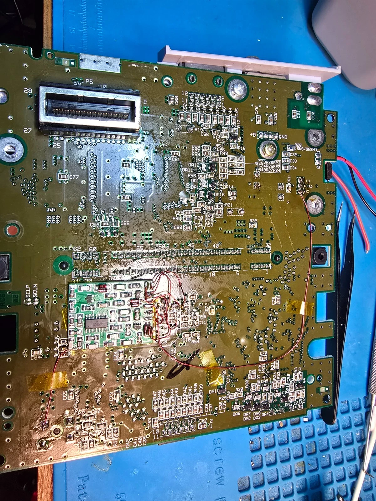 SNES motherboard underside with the RGB mod board installed