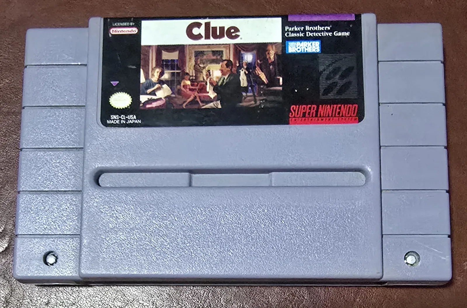 Front of an authentic Super Nintendo Clue cartridge, Parker Brothers' Classic Detective Game, licensed by Nintendo