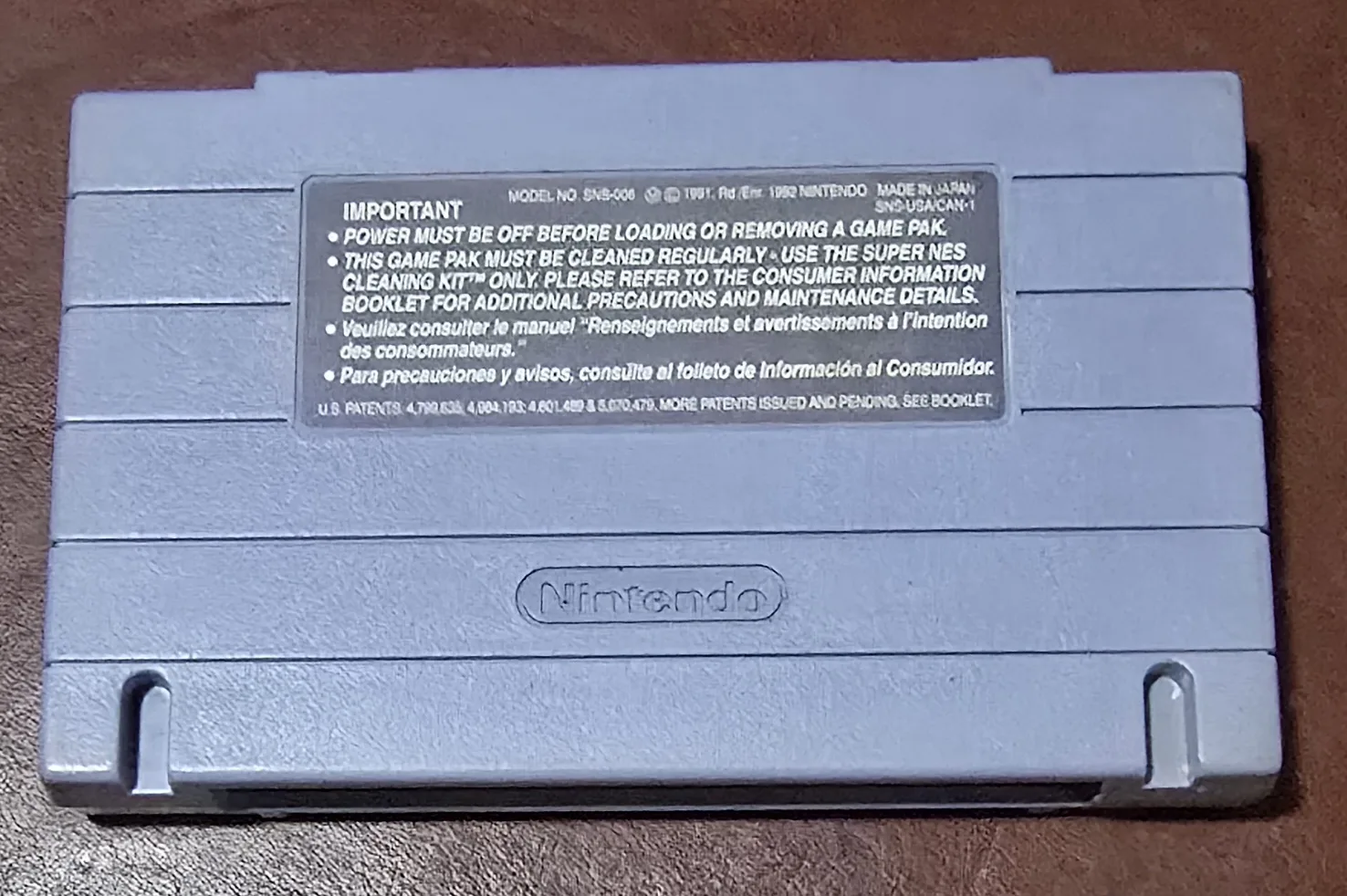 Back of the Donkey Kong Country SNES cartridge shell with the Nintendo caution label