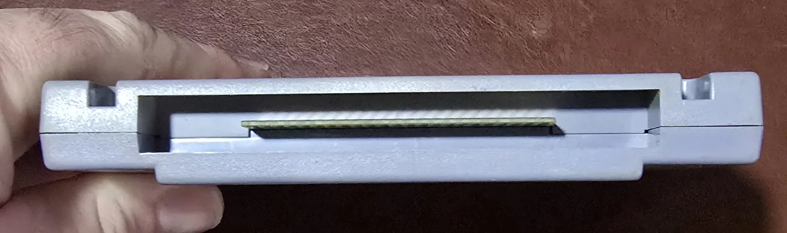 Edge of the SNES cartridge showing the cleaned gold edge-connector contacts