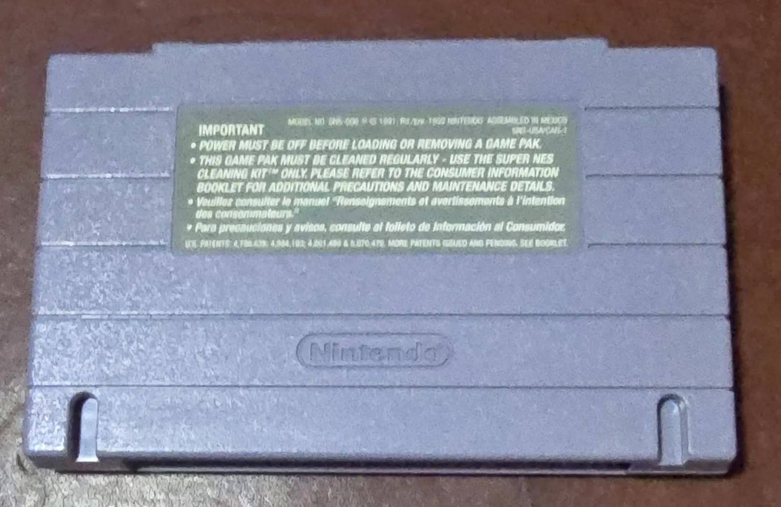 Back of the Super Caesars Palace SNES cartridge shell with the Nintendo caution label