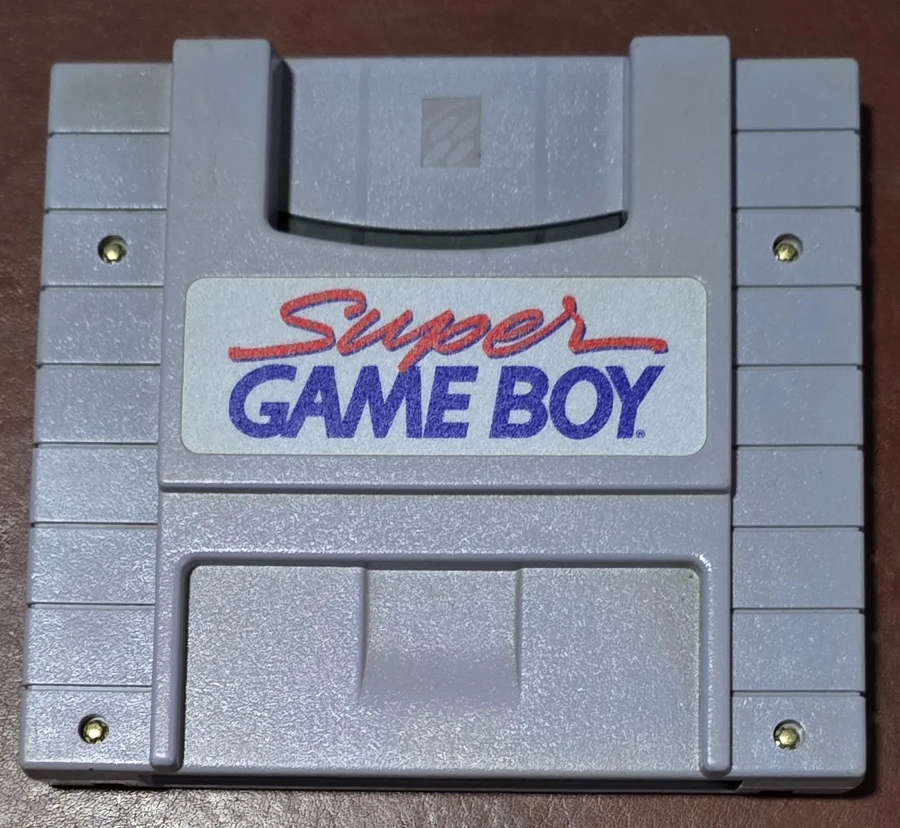 Front of an authentic Nintendo Super Game Boy cartridge for the Super Nintendo, with the red-and-blue Super Game Boy label