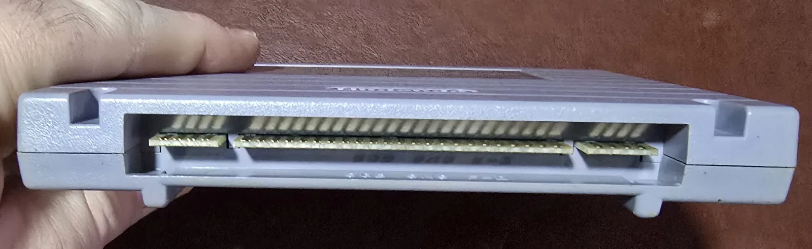 Edge of the Super Game Boy showing the cleaned SNES edge-connector contacts