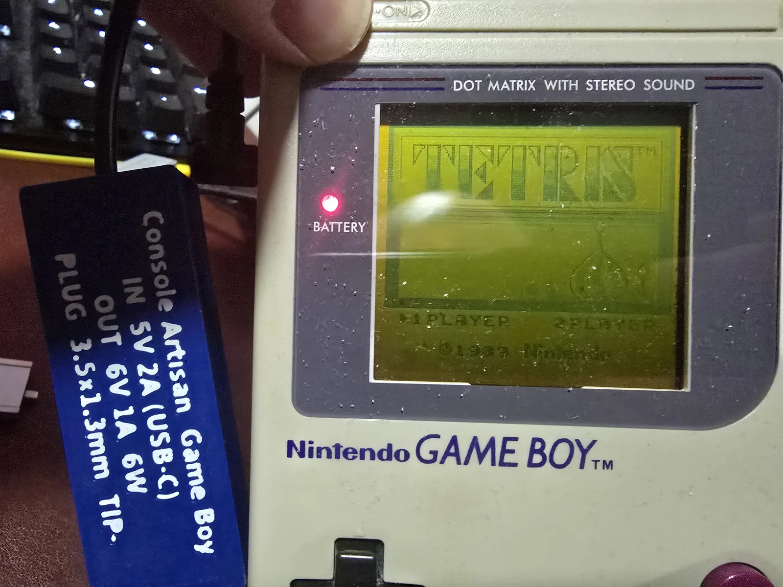 An original Nintendo Game Boy DMG-01 running Tetris, powered by the DMG Game Boy adapter